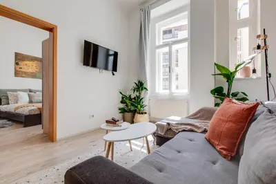 a living room with a couch and a table at Romantic apartment by the park - uaka7 in Prague