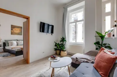 a living room with a couch and a table at Romantic apartment by the park - uaka7 in Prague