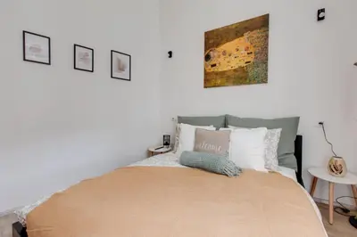 a bedroom with a large bed and pictures on the wall at Romantic apartment by the park - uaka7 in Prague