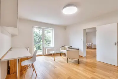 an empty living room with a table and chairs at Family Friendly Spacious Two Floor B&B Prague in Prague