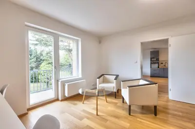 a living room with a table and chairs and a window at Family Friendly Spacious Two Floor B&B Prague in Prague