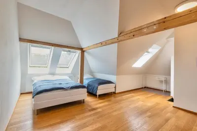 a bedroom with two beds and two windows at Family Friendly Spacious Two Floor B&B Prague in Prague