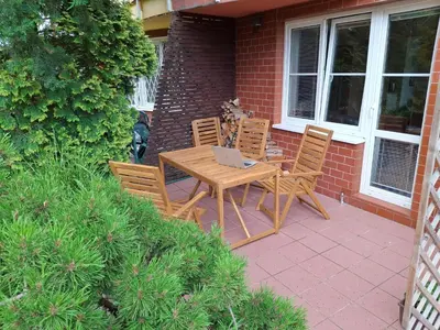 a table and chairs with a laptop on a patio at Apartmán Hajní 1368 in Prague