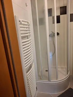 a shower with a glass door in a bathroom at Apartmán Hajní 1368 in Prague