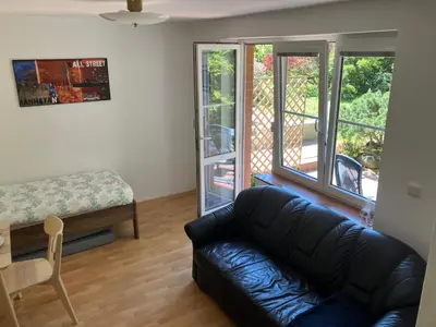 a living room with a couch and a table at Apartmán Hajní 1368 in Prague