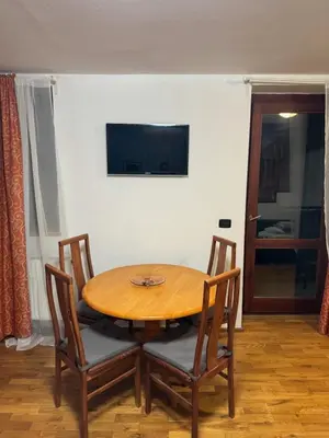 a wooden table with two chairs and a wooden table at Vitkova Duplex apartment with terrace near Florenc in Prague