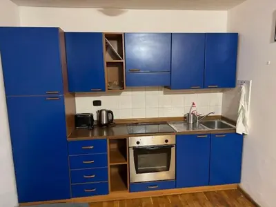 a kitchen with blue cabinets and a sink at Vitkova Duplex apartment with terrace near Florenc in Prague