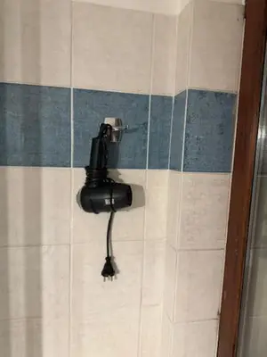 a phone on the wall of a bathroom at Vitkova Duplex apartment with terrace near Florenc in Prague