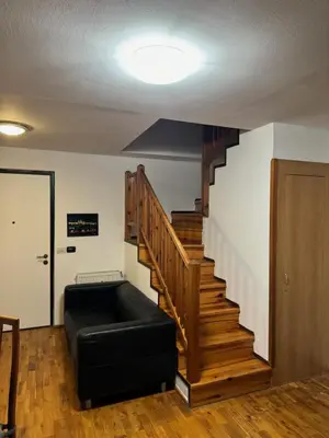 a living room with a couch and a staircase at Vitkova Duplex apartment with terrace near Florenc in Prague