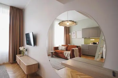 a living room with a couch and a mirror at Luxemi Apartments I City Center Premium Studio in Prague