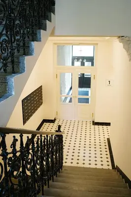 a stairway with a white door and a window at Luxemi Apartments I City Center Premium Studio in Prague