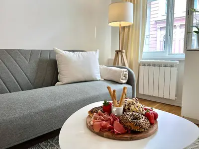 a tray of food on a table in front of a couch at Treetess City Centre Prague Apartments in Prague