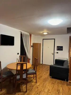 a living room with a table and chairs and a couch at 1 Bed Flat - Sleeps 4 - Pets - Smoking on terrace in Prague