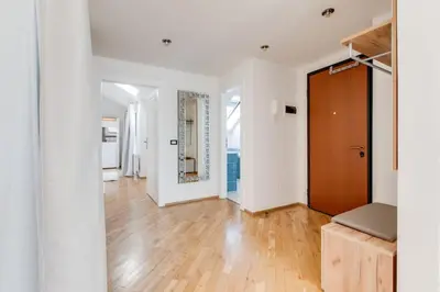 an empty living room with white walls and a wooden door at Wenceslas Square Royal Apartments in Prague