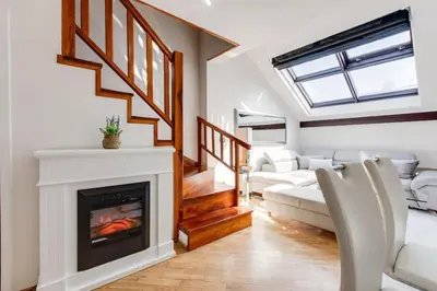 a living room with a fireplace and a couch at Wenceslas Square Royal Apartments in Prague