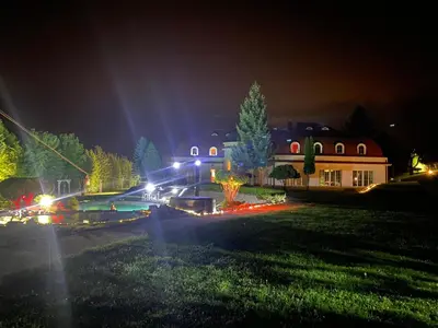 a house lit up at night with lights at DiamondHouse vila & wellness in Kolín