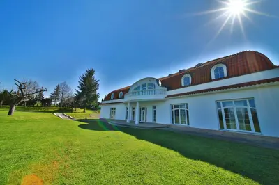 a large white house with a red roof at DiamondHouse vila & wellness in Kolín