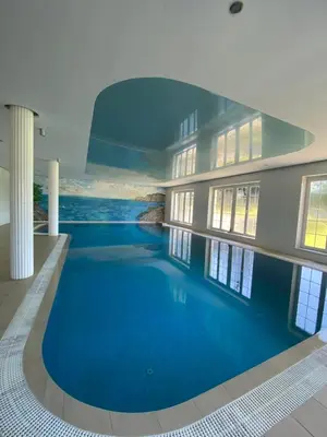 a swimming pool in the middle of a building at DiamondHouse vila & wellness in Kolín