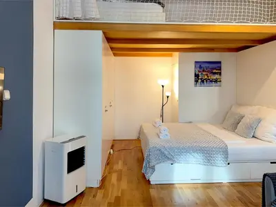 a small bedroom with a bed and a tv at 3Brothers Homestay in Prague
