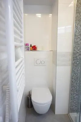 a white bathroom with a toilet and a shower at 3Brothers Homestay in Prague