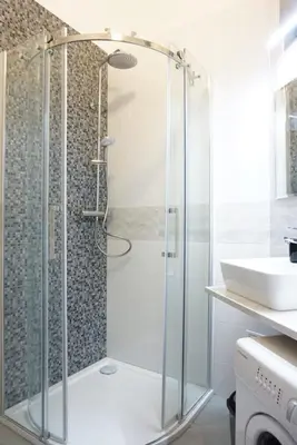 a shower with a glass door in a bathroom at 3Brothers Homestay in Prague