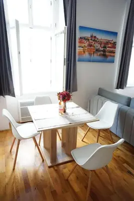 a table and chairs in a living room with a couch at 3Brothers Homestay in Prague