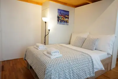 a bedroom with a bed with two towels on it at 3Brothers Homestay in Prague