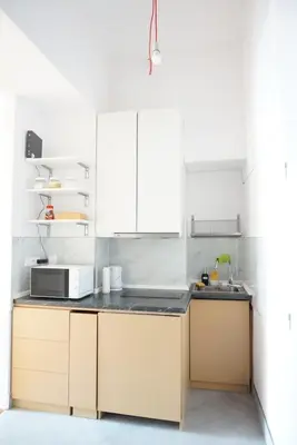 a kitchen with white cabinets and a microwave at 3Brothers Homestay in Prague