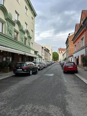 a city street with cars parked on the side of the road at Pražský byt s dobrou dostupností in Prague