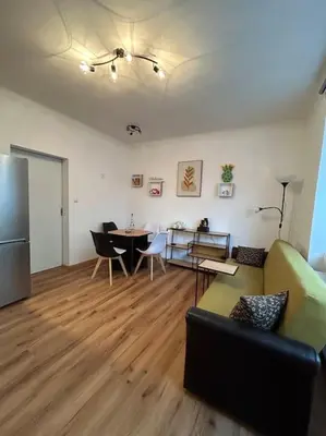 a living room with a couch and a table at Pražský byt s dobrou dostupností in Prague