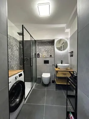 a bathroom with a sink and a washing machine at Pražský byt s dobrou dostupností in Prague