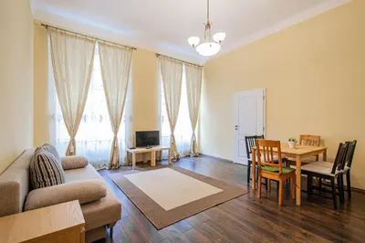 a living room with a couch and a table at Spacious oasis in Prague's Heart in Prague