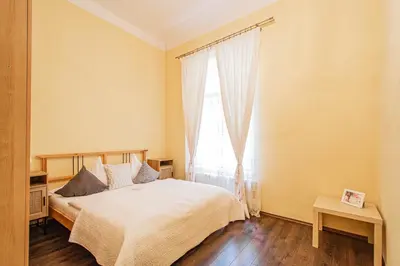 a bedroom with a bed and a large window at Spacious oasis in Prague's Heart in Prague