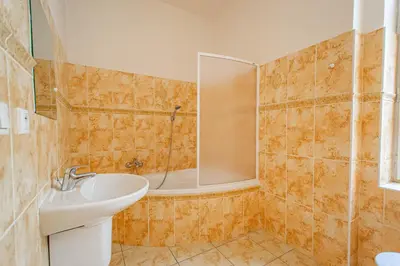 a bathroom with a sink and a mirror and a tub at Spacious oasis in Prague's Heart in Prague