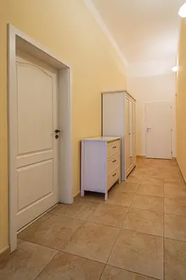 an empty room with a dresser and a door at Spacious oasis in Prague's Heart in Prague