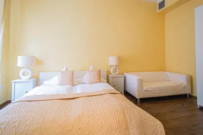 a bedroom with a large bed and a chair at Spacious oasis in Prague's Heart in Prague