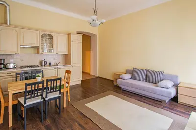 a kitchen and a living room with a couch and a table at Spacious oasis in Prague's Heart in Prague