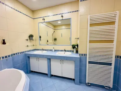 a bathroom with two sinks and a large mirror at Maiselova Old Town Apartment in Prague