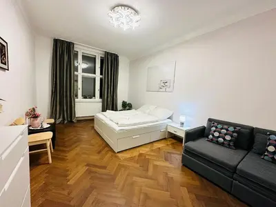 a living room with a bed and a couch at Maiselova Old Town Apartment in Prague
