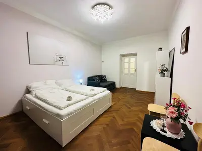 a bedroom with a white bed in a room at Maiselova Old Town Apartment in Prague