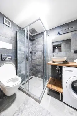 a bathroom with a shower and a toilet and a sink at Bohéme Apartments - Karlín in Prague