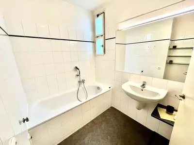 a white bathroom with a tub and a sink at Luxury Apartment in Old Town in Prague