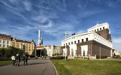a group of people walking in front of a building at Best location in Prague! 4 bedrooms and super host! in Prague