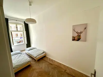 a room with a bed and a picture of a deer on the wall at Best location in Prague! 4 bedrooms and super host! in Prague