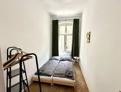 a bedroom with a bunk bed in a white room at Best location in Prague! 4 bedrooms and super host! in Prague