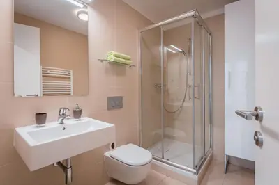 a bathroom with a sink toilet and a shower at Old Town Square Studio in Prague
