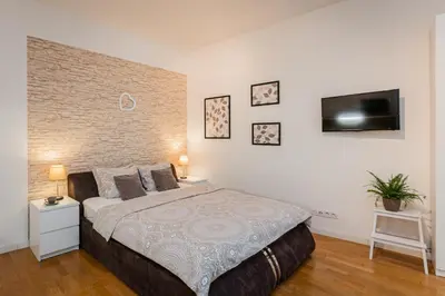 a bedroom with a large bed and a flat screen tv at Old Town Square Studio in Prague