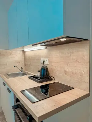 a kitchen counter with a tea kettle on a stove at My Mozartova in Prague