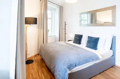 a bedroom with a large bed with blue pillows at River View Apartment in Prague