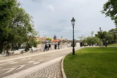 a street light in a park next to a river at River View Apartment in Prague